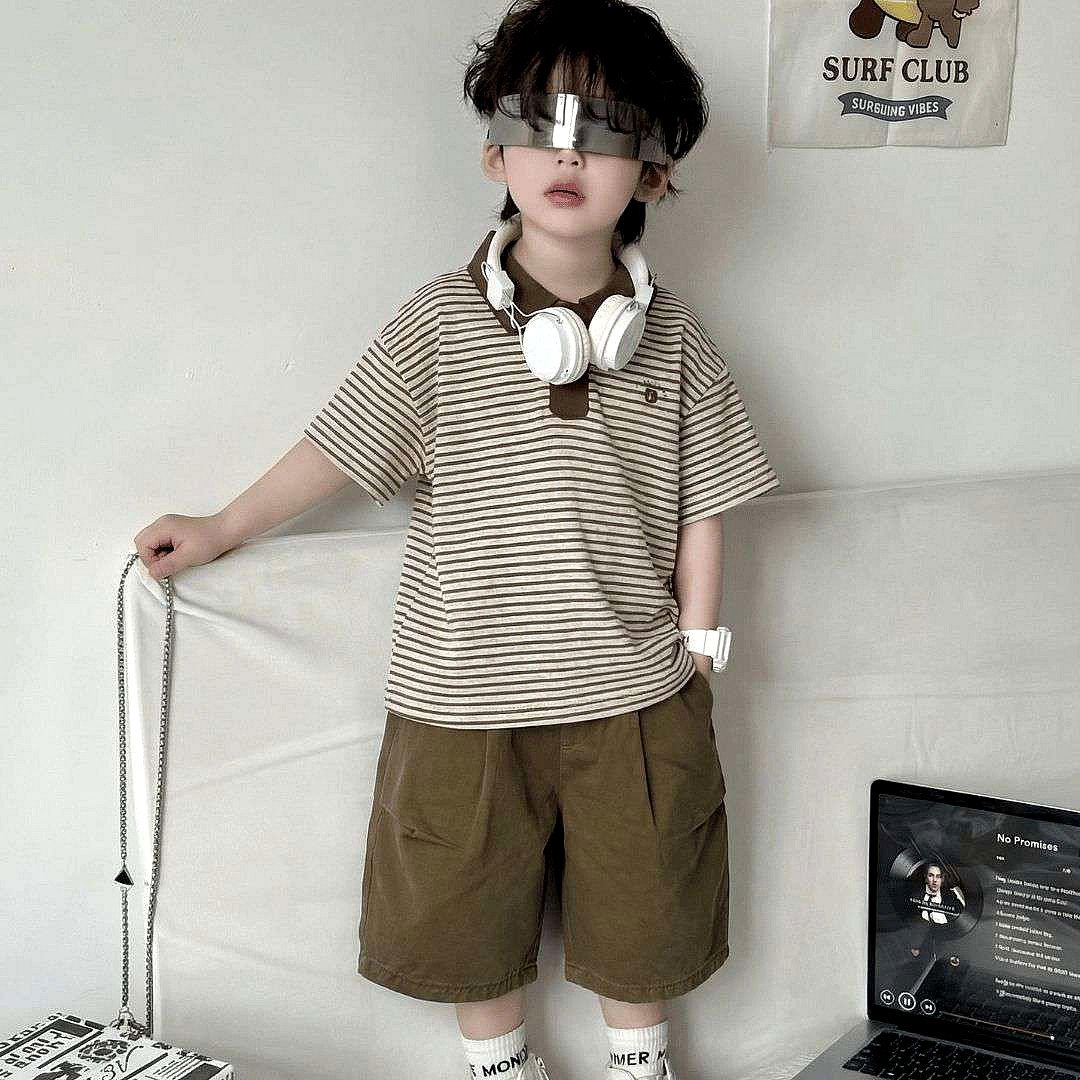 Boy wearing a beige and brown striped polo t-shirt with brown shorts and white headphones